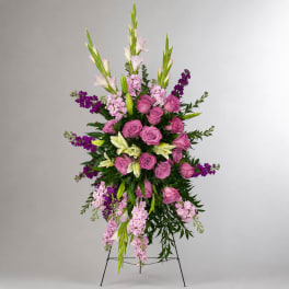 Tall standing floral spray with pink roses, lilies, and purple accents