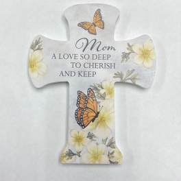 Cross-shaped memorial plaque with butterflies and flowers reading "Mom"