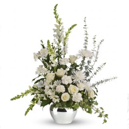 White floral arrangement in a silver vase with tall stems