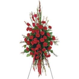 Tall standing spray of red carnations on an easel