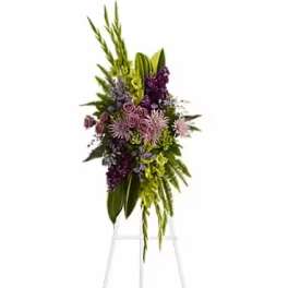 Tall floral spray with purple and green flowers on a stand