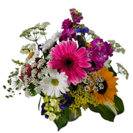Mixed bouquet with pink gerbera daisies, sunflowers, and white daisies