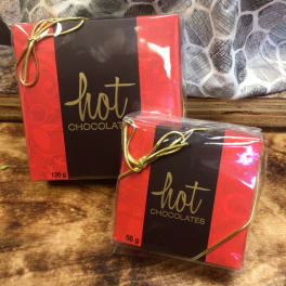 Two boxes of hot chocolates tied with gold ribbon
