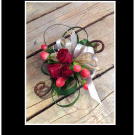 Small bouquet of red roses with ribbon loops and pink berries