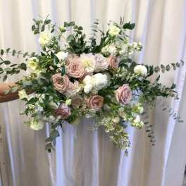 Handheld bouquet of blush roses and white flowers with airy greenery