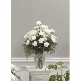 White floral arrangement in a clear glass vase