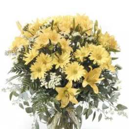 Yellow flowers arranged in a clear glass vase