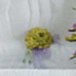 Blurred yellow-green floral arrangement with purple accents