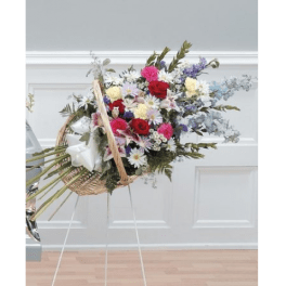 Large mixed flower basket on a stand with pink, red, white, and purple blooms