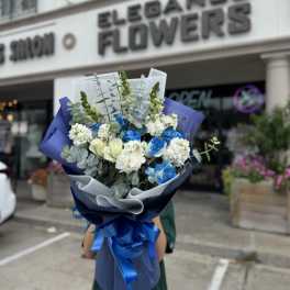 Bouquet of blue and white roses with white filler flowers