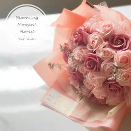 Pink and lavender rose bouquet wrapped in peach paper