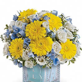 Yellow gerbera daisies and white roses in a glass cube vase