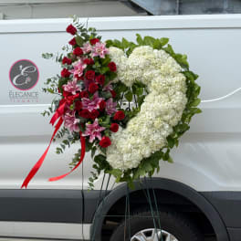 Heart-shaped floral standing spray with red roses, pink lilies, and white hydrangeas