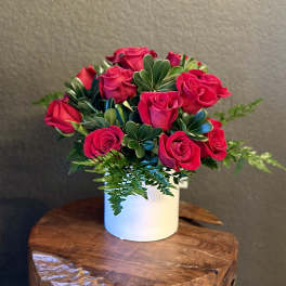 Bouquet of hot pink roses in a white vase