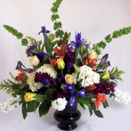 Colorful bouquet of mixed flowers in a black vase