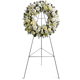 White floral wreath on a metal easel