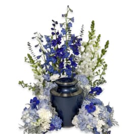 Blue and white floral urn arrangement with tall delphinium and hydrangea clusters