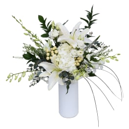 White lilies and roses in a tall white vase
