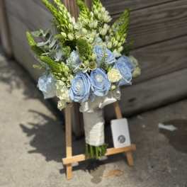 Blue roses and white flowers in a hand-tied bouquet