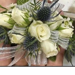 White spray rose and blue thistle wrist corsage with silver ribbon