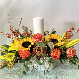 Sunflower and rose centerpiece with a white pillar candle