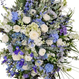 Large bouquet of white roses, blue hydrangeas, and purple flowers