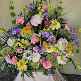 Large mixed floral spray with pink, yellow, purple, and white blooms