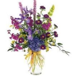 Colorful mixed flower bouquet in a clear glass vase