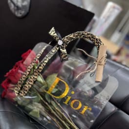 Bouquet of red roses in a clear gift bag with a decorative handle