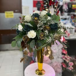 White and dark roses in a gold vase with eucalyptus and baby's breath