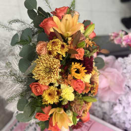 Mixed bouquet with orange roses, yellow lilies, and chrysanthemums