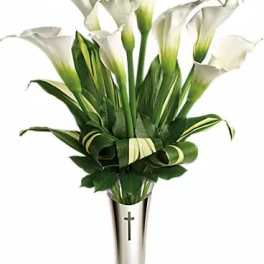 White calla lilies in a silver vase with a cross