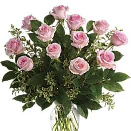 Pink roses arranged in a clear glass vase