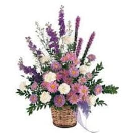 Basket arrangement of pink and purple flowers with tall spikes