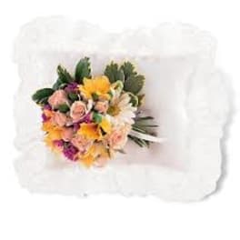 Mixed bouquet of pink roses and yellow daisies on a white pillow