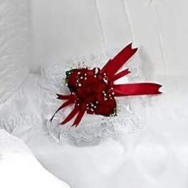 Red rose corsage with white lace and ribbon
