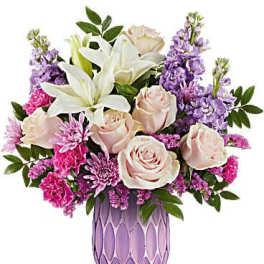 Pink roses and white lilies in a purple vase