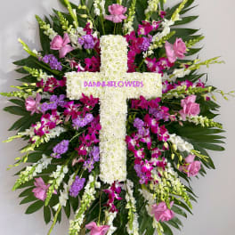 Large floral cross with pink, white, and purple flowers