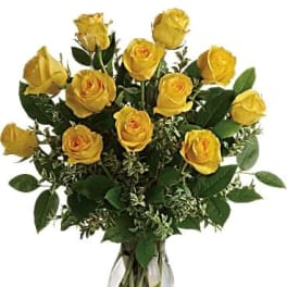 Yellow roses arranged in a clear glass vase