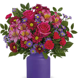 Mixed pink and purple bouquet in a purple vase