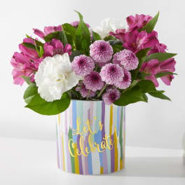 Pink and white flowers in a striped gift box with "Let's Celebrate" text