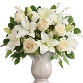 White lilies and cream roses in a gray vase
