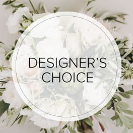 White floral arrangement with a "Designer’s Choice" label
