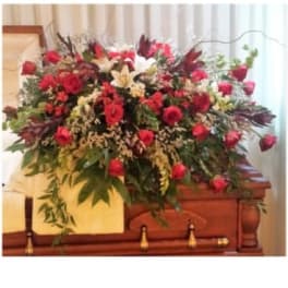 Large red and white floral spray on a casket