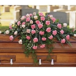Pink and white carnations arranged on a casket