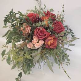 Bouquet of red and blush roses with eucalyptus greenery