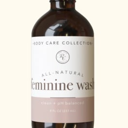 Amber pump bottle labeled feminine wash