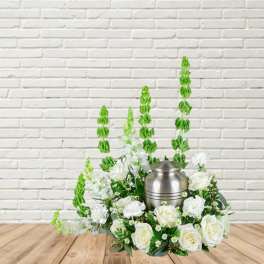 White floral arrangement with a silver urn centerpiece
