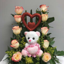 Rose arrangement with a teddy bear and glitter heart decoration