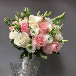 Pink and white rose bouquet in a clear glass vase